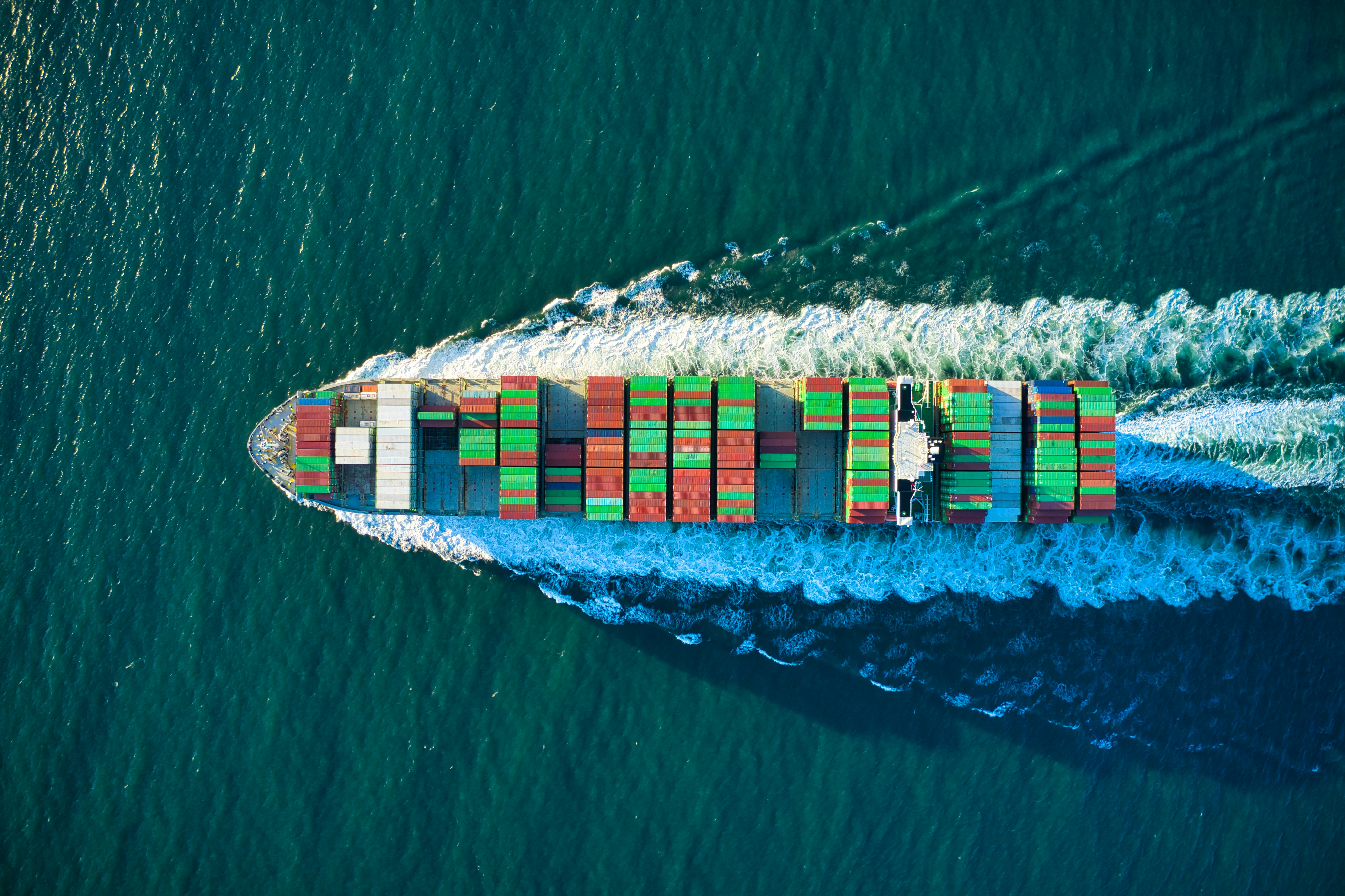 Aerial view of a container ship moving across the ocean